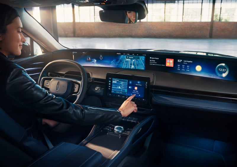 The driver of a 2024 Lincoln Nautilus® SUV interacts with the center touchscreen. | Astro Lincoln in Pensacola FL